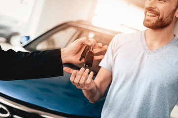 Showroom Dealer The Gives Car Keys To The Buyer.