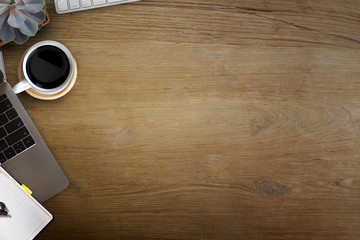 Wood desk coffee with office supplies workspace and copy space, Top view
