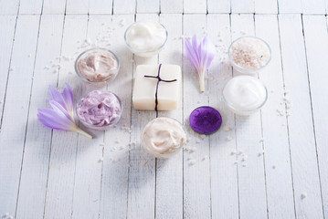 cosmetic cream variations, soap and bath salt with autumn crocus herbal flower on white wooden table