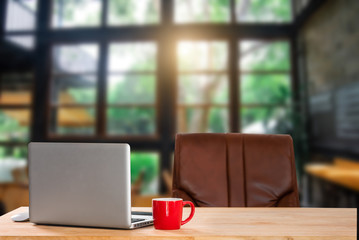 workspace with computer, laptop, office supplies, and coffee cup at office. desk work concept. in morning light