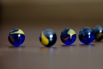 glass Marbles on dark wooden floor