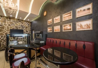 Fotobehang Contemporary decorated interior of pizza restaurant with shelves and seats © poplasen