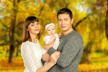 happy family in autumn park enjoying their time