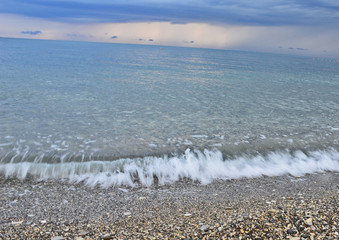 sea surf in the background of rain clouds and sunset