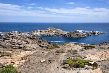 Spain, Catalonia, Cap de Creus: Panorama view of famous beautiful Spanish tourist destination with rocky cliff, laguna, blue sea water and cloudy sky in the background - concept nature.