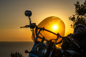 Motorcycle on a background of a beautiful summer sunset.