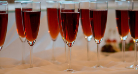 Close up of front view of glasses with red drinks
