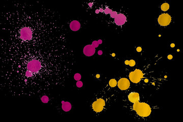  yellow and red paint stains on a black background. isolate. blots, bays