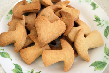 Homemade cookies cooked from short pastry. Cookies in the form of mushrooms on a white plate. Bakery products                               