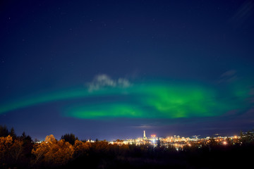 northern lights above Reykjavik in Iceland at night