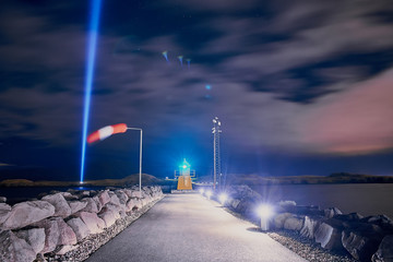 Lighthouse and Imagine Peace Tower on Videy island in Reykjavik at night