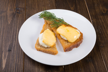 Fried toasts with baked egg and cheese