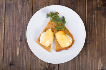 Fried toasts with baked egg and cheese