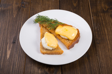 Fried toasts with baked egg and cheese