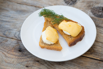 Fried toasts with baked egg and cheese