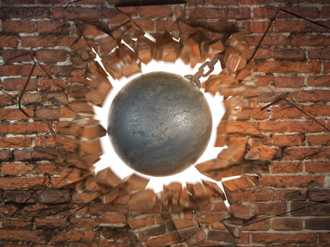Wrecking ball destroying the brick wall © Maksym Yemelyanov