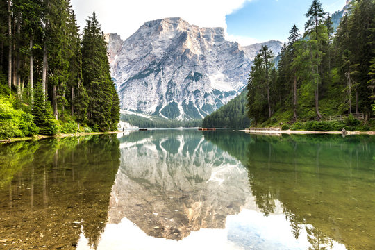 Lake braies also known as Lago di Braies. The most beautiful lake in Dolomites and Alps. A huge mountain reflecting in the water before sunset. National park Fanes Sennes Braies, South Tyrol, Italy. 