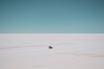 Car driving in a white sea