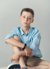boy posing in fashionable shirt and shirts in studio