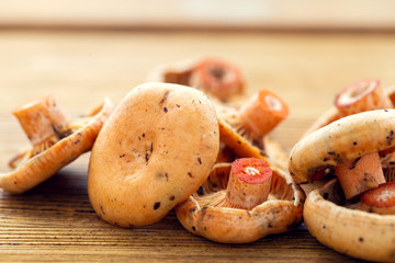 Saffron milk cap on a wooden table with shallow depth of field. Rare mushrooms, rarity and delicacy...