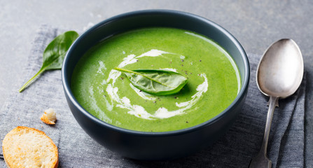 Spinach soup with cream in a bowl. Close up.