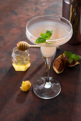 The rose exotic cocktail and figs, honey on brown stone background , copy space