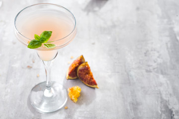 Jack Rose Cocktail with figs and honey on light background over windows, flat lay with copy space