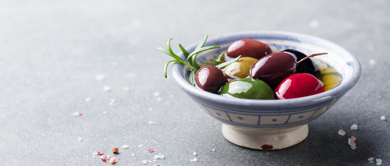 Olives assortment in bowl with oil. Copy space.
