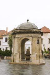 Historical Fountain. Fount by St Emeric Church on Jurisics Square, old town. Hungary, Koszeg, western Transdanubie, Hungary.