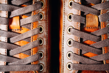 Close up of pair of men's brown leather shoes. Lacing on shoes