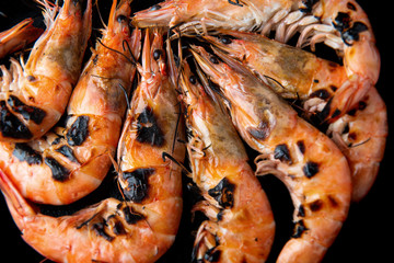 Grilled shrimp with charcoal flaming fire.