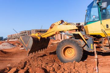 Fototapeta premium Construction Industrial Machine Bucket Tipping Earth Building Site