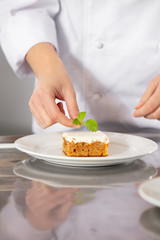 Female fhef decorate dessert cake with lemon leaf