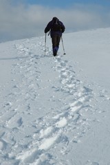 Man hiking in winter mountains