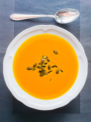 Pumpkin soup with pumpkin seeds ready to eat on plate