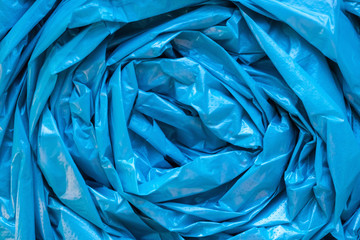 Blue garbage bag texture. Cellophane twisted crumpled plastic background