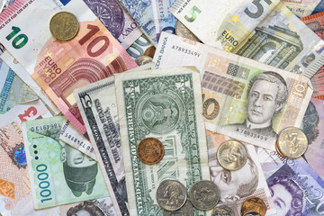 Background-style image of several banknotes and coins from various countries rapresenting the concept of wordlwide stock and echange rate