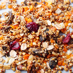 Granola, muesli on wooden table. Healthy breakfast. Organic oats with seeds, berries and nuts.