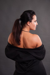 Sexual beautiful naked woman in a black jacket view from the back