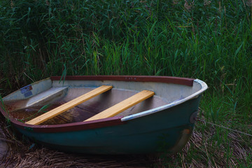 Old Metal Rowing Boat On The Background Of Reeds