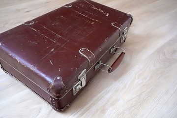Old suitcase on the floor in an empty room