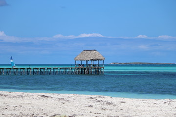 Beautiful gazebo in the Blue water. Perfect summer day on the beach