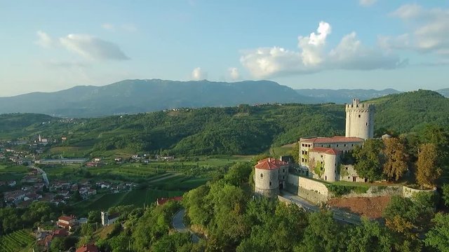 Aerial footage of medieval castle on a hill above Vipava valley