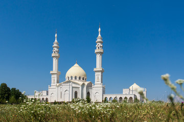 Fototapeta na wymiar White mosque on blue sky background.