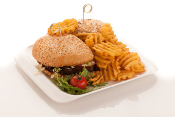 Gamburger with frenchfries on a plate isolated over white background