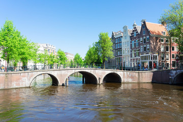 Fototapeta premium historical houses of Amsterdam over canal ring landmark in old european citye, Holand Netherlands. Amsterdam spring scenery