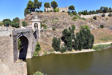 Fototapeta na wymiar Alcantara Bridge ( Puente de Alcantara ) is an arch bridge in Toledo, Spain, spanning the Tagus River