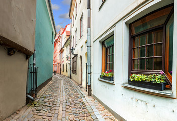 Morning in narrow medieval street in old city of Riga, Latvia, Europe