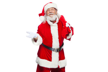 Christmas. Santa Claus is suffering from back pain and holds a red bag with gifts on his back. Isolated on white background.