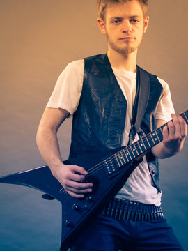 Young man playing electric guitar